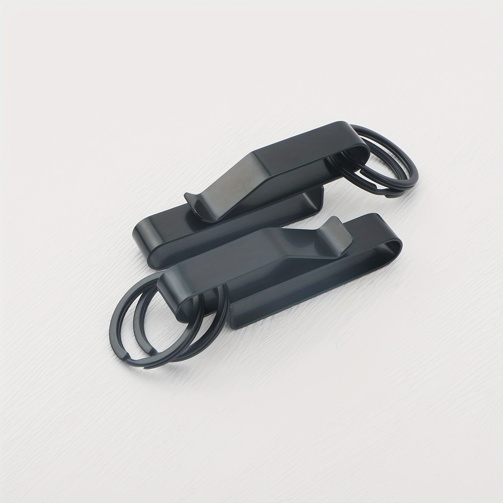 A black stainless steel belt key holder with a loop key ring.