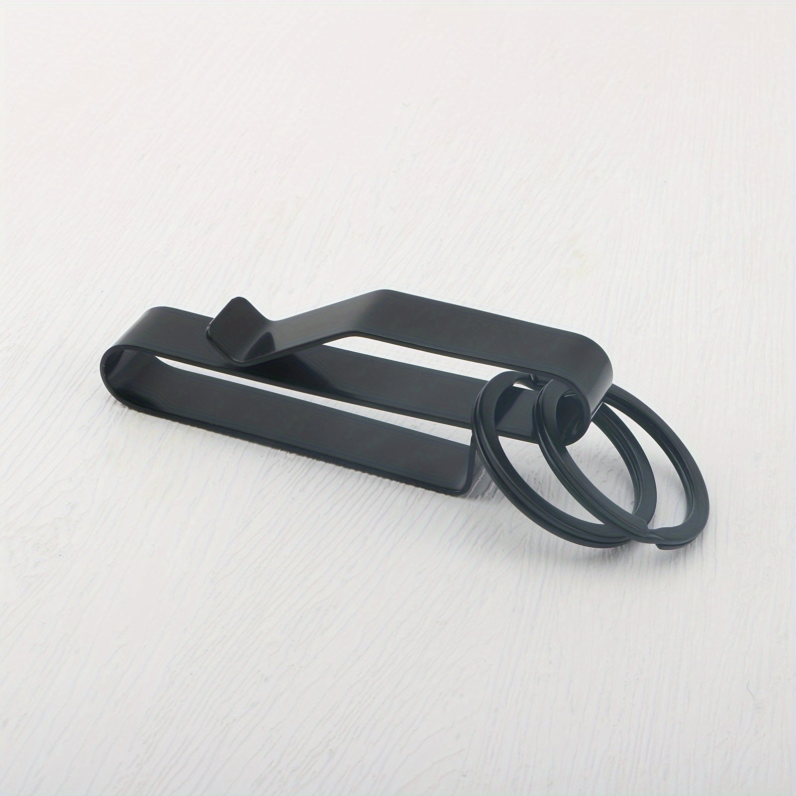 A black stainless steel belt key holder with a loop key ring.