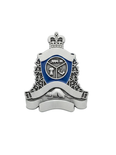 Metallic badge with a central emblem and decorative elements on a white background