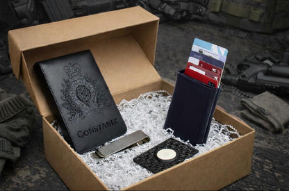 Badgeboys notebook and wallet bundle with engraved notebook, wallet, airtag holder, and money clip on a tactical-themed background.