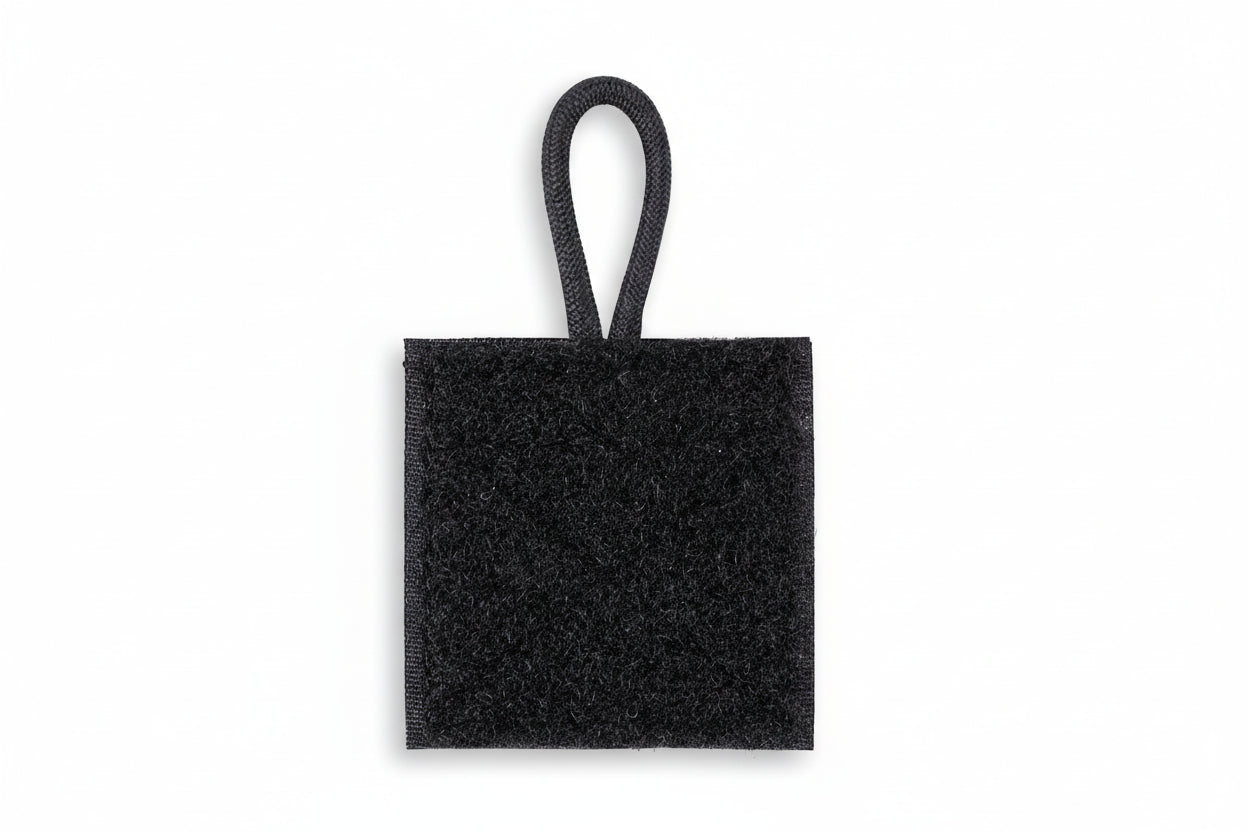 A black radio microphone holder with a hook and loop design, featuring a small loop for attachment.