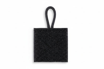 A black radio microphone holder with a hook and loop design, featuring a small loop for attachment.