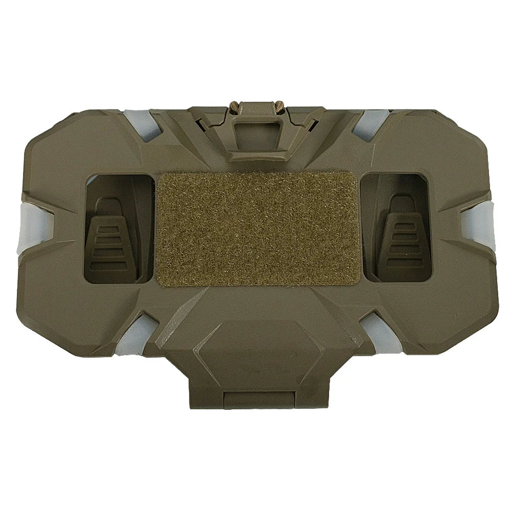 A tactical vest or body armor plate in coyote brown, featuring a central hook-and-loop patch and two side slots, shown against a plain white background.
