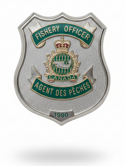 Shield-shaped badge for Fishery Officer with Canadian emblem on a white background