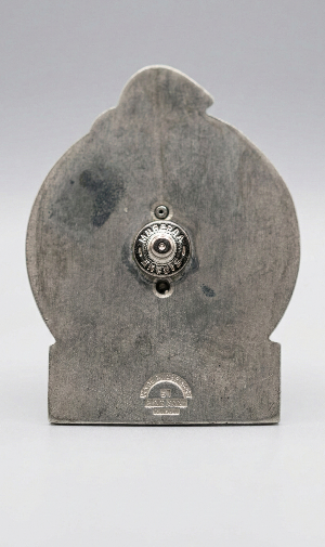 Decorative stone object with a central metal component on a gray background